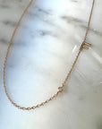 14K Gold Initial Necklace – Custom Letter & Diamond Accent Necklace on a quartz display- Camille Jewelry