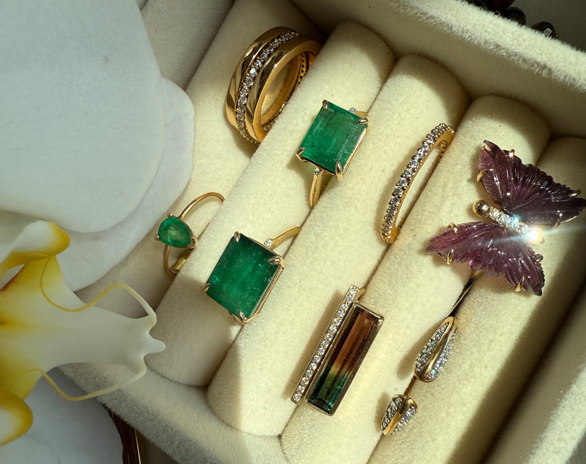 Jewelry set including gemstone and diamond gold rings in a display case | Camille Jewelry
