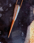 Phoenix bird beak necklace in gold on a black display with Camille Jewelry logo overlay.