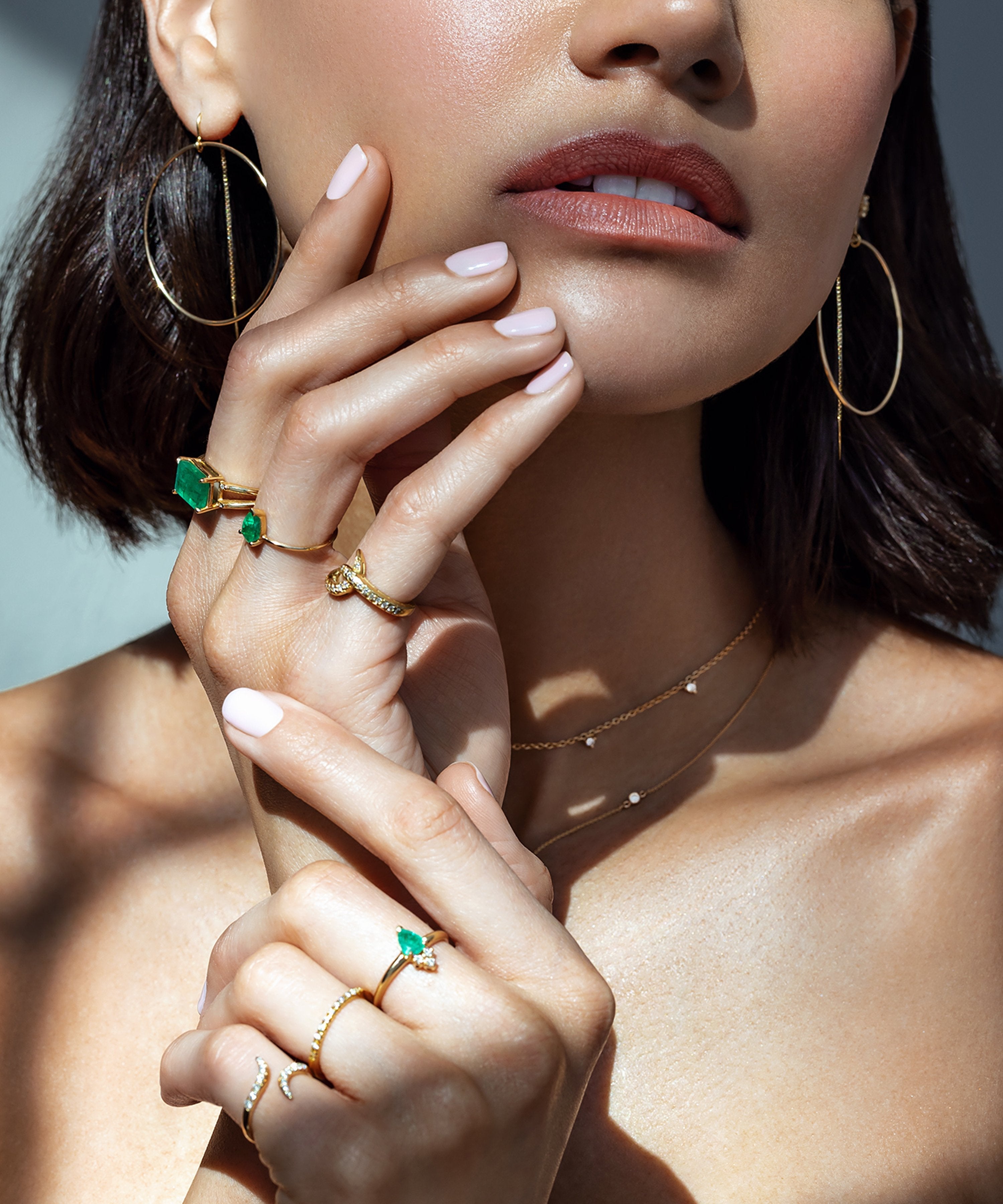 Woman wearing the Venus 14K Gold Emerald Pear Ring with Diamonds