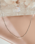 Magnetic convertible bar chain close up necklace in gold plated brass on a white background by Camille Jewelry