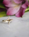 Diamond and Gold Pinky Ring for Women on display with a flower in background - Camille Jewelry