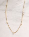 layering diamond necklace styling on marble display - Camille Jewelry