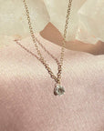 Woman wearing a floating diamond necklace in solid 14K yellow gold by Camille Jewelry
