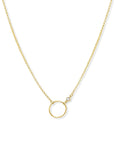 Gold circle necklace in 14K gold filled with bezel set cubic zirconia pendant on a white background by Camille Jewelry