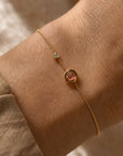 Gold filled bracelet rounded box chain with an organic tourmaline gemstone and CZ accent on wrist by Camille Jewelry.