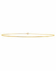 A delicate, thin 14k gold filled wire choker necklace with a small central loop closure, shown against a solid white background by Camille Jewelry