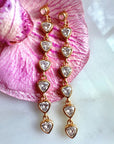Linear trillion stone Dangle Earrings on a flower backdrop- Camille Jewelry