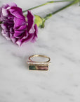 14K yellow gold Diamond Bar Tourmaline Gemstone Ring with flower in background on stone - Camille Jewelry