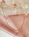 Magnetic convertible gold bar chain necklace in gold plated brass on a white background by Camille Jewelry