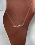Personalized 14K Yellow Gold Script nameplate Mimi Necklace on model's neckline - Camille Jewelry