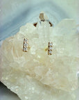 Mini Diamond Bar Stud Earrings on a quartz display by Camille Jewelry