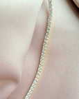 Close up of a tennis necklace with 2.5mm prong set cubic zirconia in gold plated sterling silver extreme by Camille Jewelry
close up