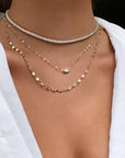 Woman wearing a modern tennis necklace in gold plated sterling silver by Camille Jewelry
