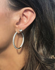 Woman wearing pavé hinged hoop earrings in 14K gold plated sterling silver by Camille Jewelry