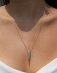 Large cubic zirconia bird beak necklace inspired by the Phoenix on a woman's necklace from Camille Jewelry