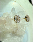 Pavé Diamond Stud Earrings in 14K yellow gold on a quartz stone display by Camille Jewelry