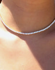 Woman wearing a modern tennis necklace in gold plated sterling silver by Camille Jewelry