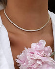 Woman wearing a modern tennis necklace in gold plated sterling silver by Camille Jewelry