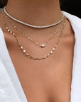 Woman wearing a modern tennis necklace in gold plated sterling silver by Camille Jewelry