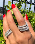 Woman wearing a skinny square ring in gold plated sterling silver stacked with other rings by Camille Jewelry