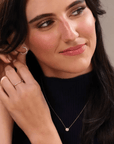 Small diamond hoop earrings in lab created on model touching her ear - Camille Jewelry