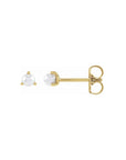 Tiny pearl stud earrings in 14K yellow gold on a white background by Camille Jewelry