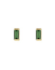 Pair of green tourmaline tiny stud earrings in 14k yellow gold on a white background by Camille Jewelry