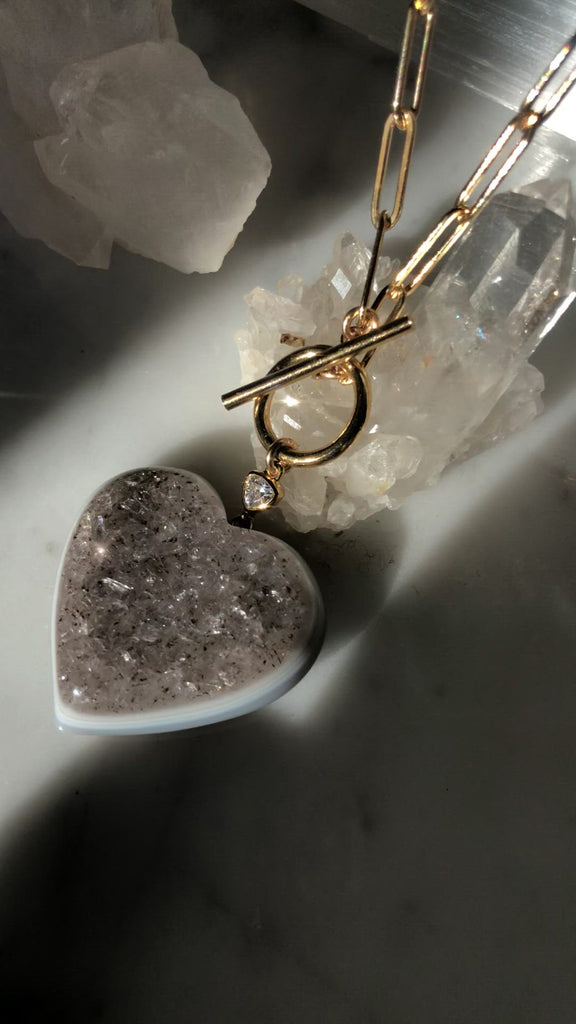 Quartz heart druzy pendant on 14K gold filled paperclip chain with toggle front closure at Camille Jewelry.