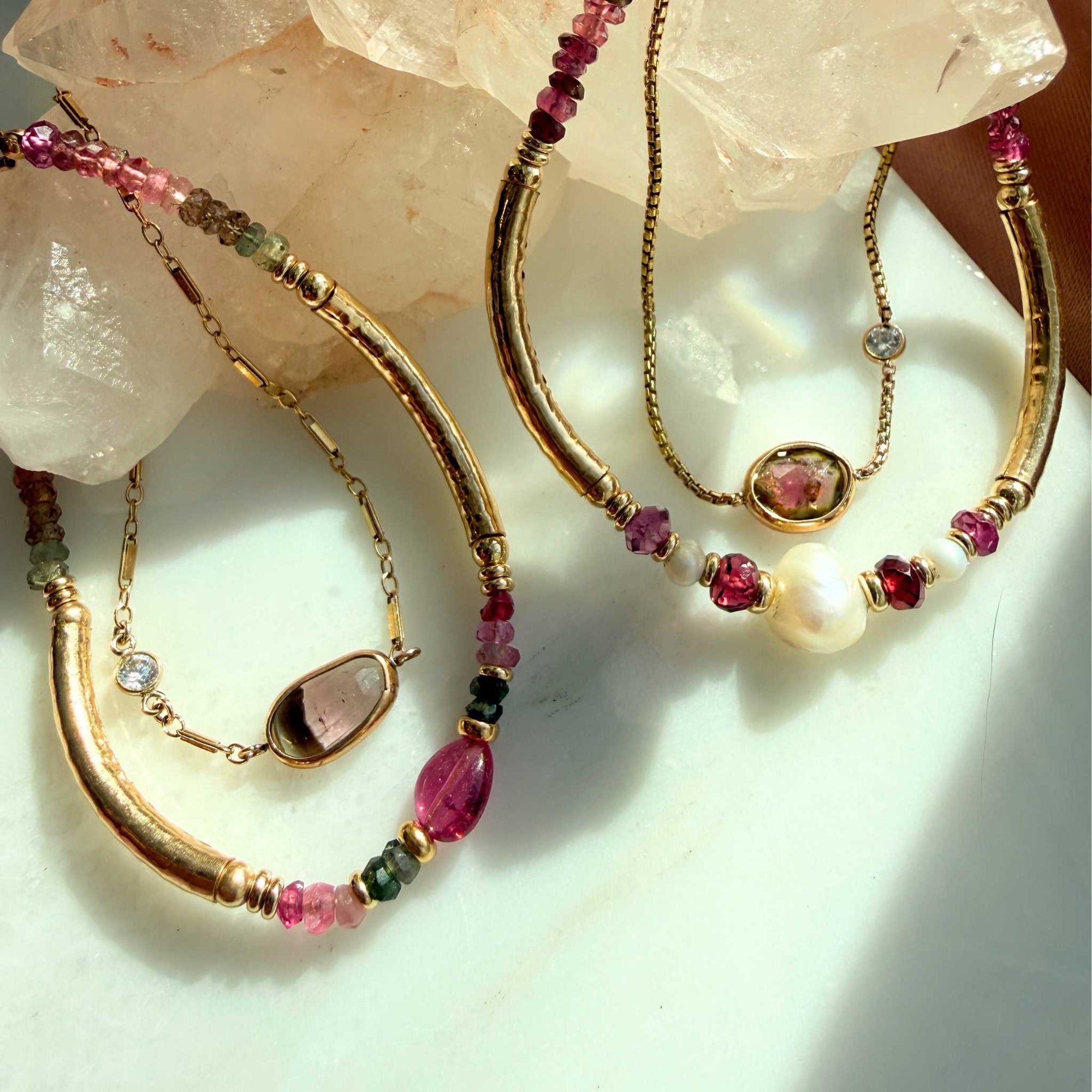 gold filled bracelets in pink beaded and set tourmaline gemstones on display. 