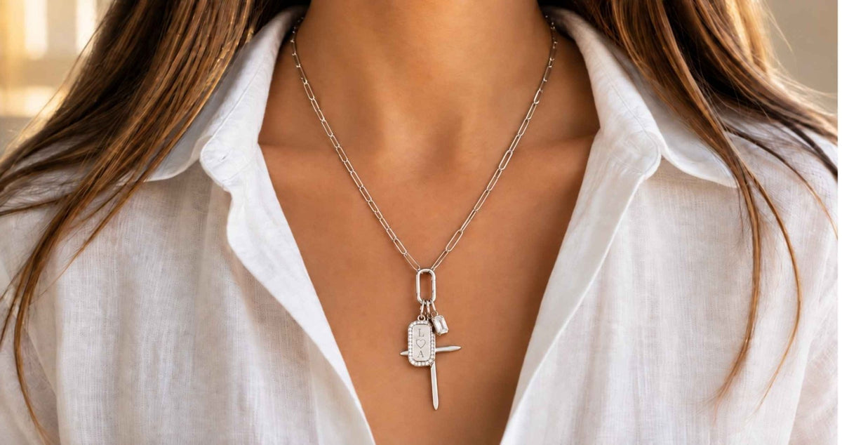 white gold necklace in 14K worn on models necklace with chain charm holder and cluster of charms by Camille Jewelry