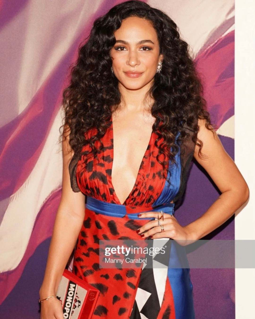 Actress Aurora Perrineau in a red dress wearing the Phoenix collection gold jewelry by Camille Jewelry. 
