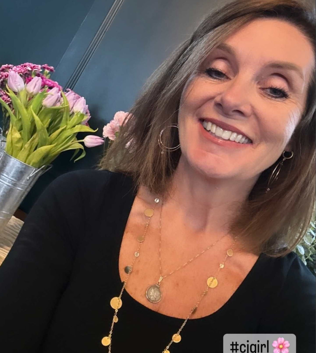 Gold disk charm necklace layered and gold filled hoop earrings on woman smiling - Camille Jewelry