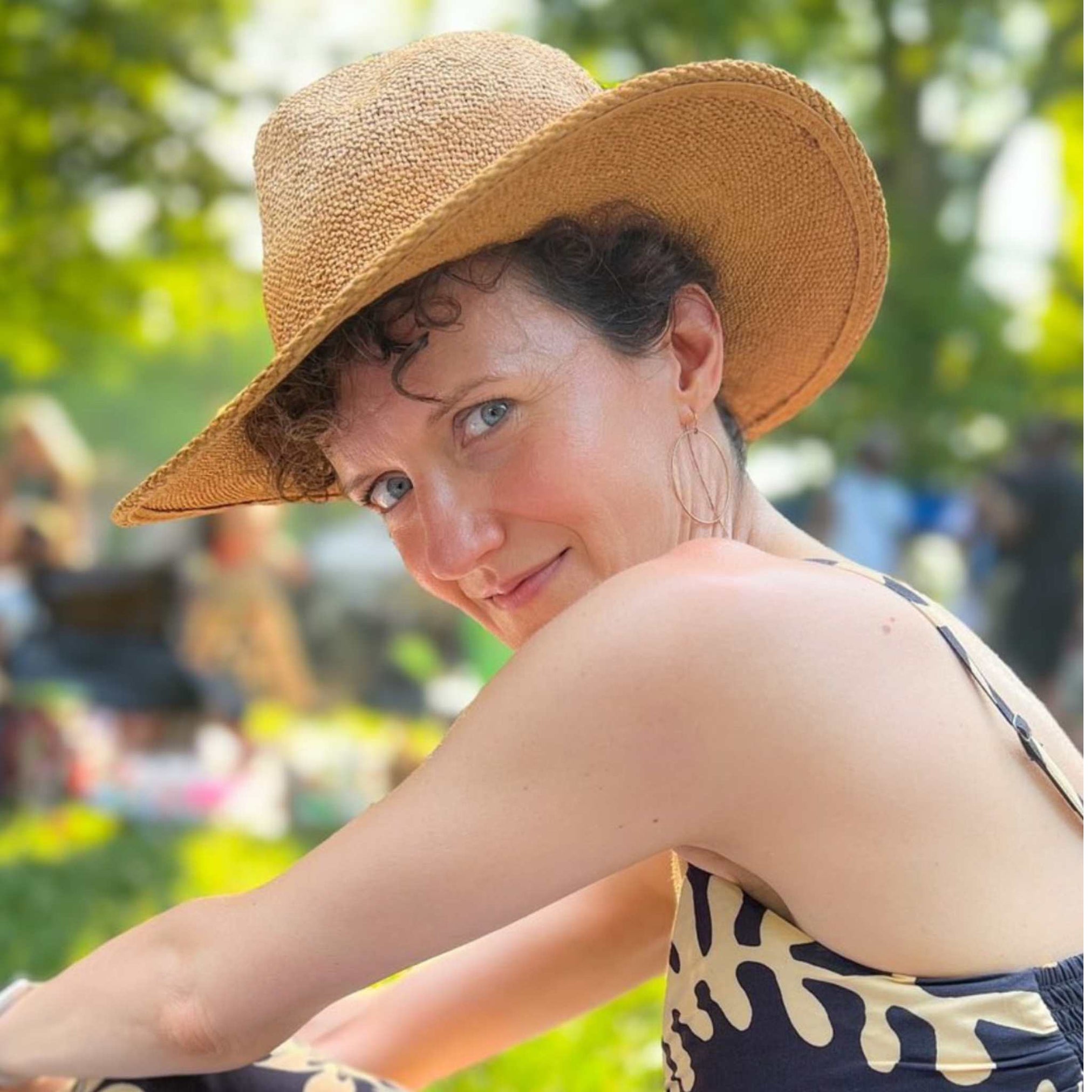 gold filled threader hoop earrings on woman with hat - Camille Jewelry
