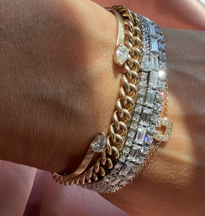 Gold chain bracelets with diamond tennis bracelets on a wrist | Camille Jewelry