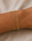 Woman wearing a figaro chain bracelet 2.5mm & 4.5mm in 14K gold filled with a toggle closure by Camille Jewelry