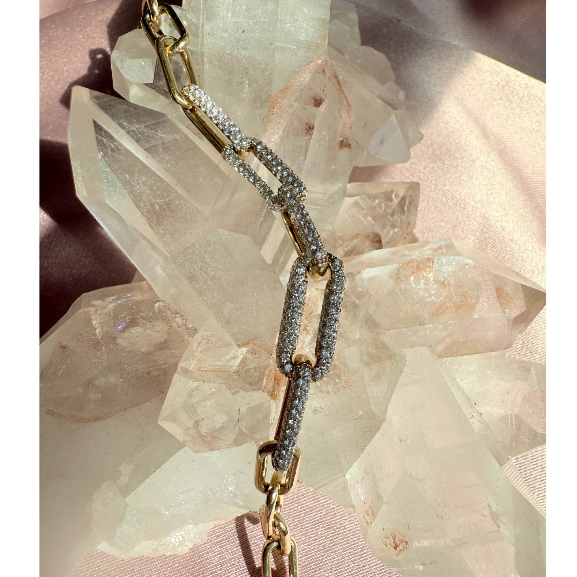 Gold Paperclip bracelet on a crystal background by Camille Jewelry