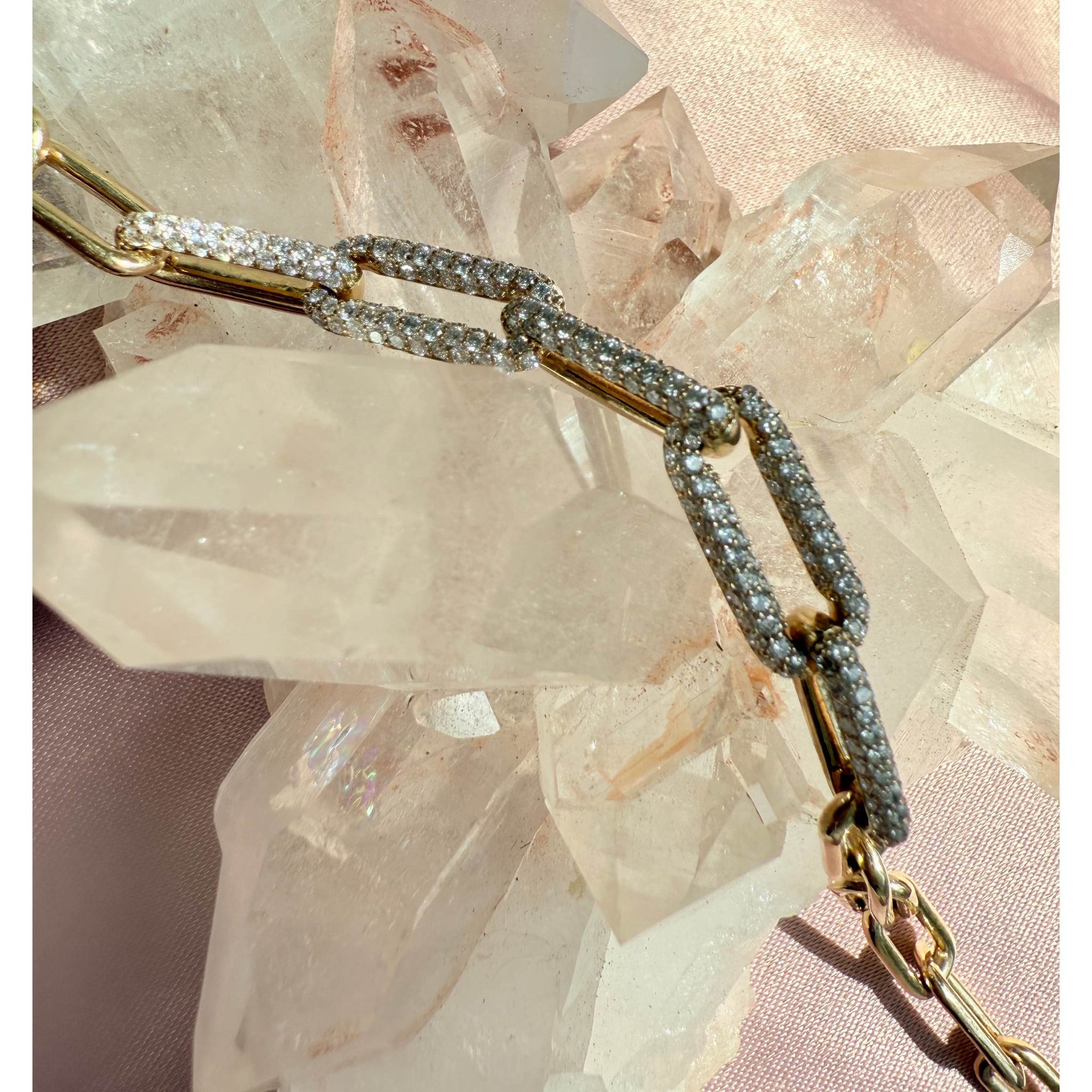 Gold paperclip bracelet with lab diamonds on a crystal background by Camille Jewelry.