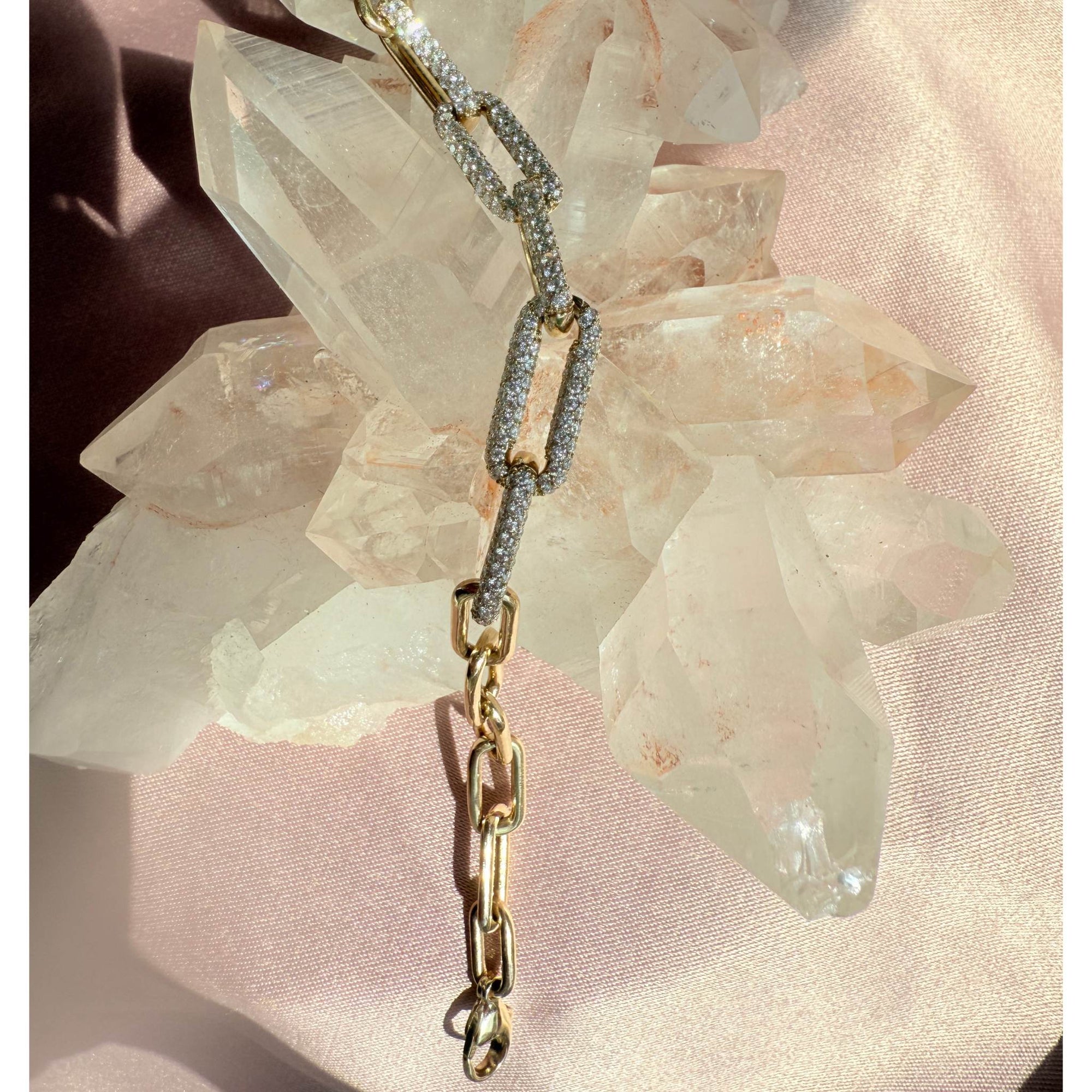Yellow gold paperclip diamond Bracelet  on a pink crystal background by Camille Jewelry.