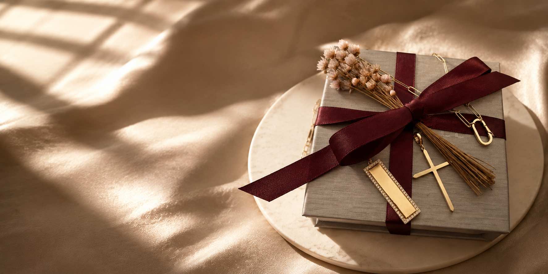 Jewelry gifts for women of gold cross and plaque on a gift box with soft lighting by Camille Jewelry. 