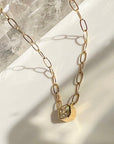 Asscher Cut Moissanite Pendant Necklace in 14K Gold on a quartz background- Camille Jewelry