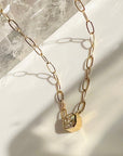 Asscher Cut Moissanite Pendant Necklace in 14K Gold on a quartz background- Camille Jewelry