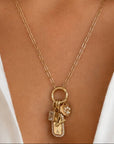 Gold jewelry for women who is wearing personalized charms on a models close up neckline by Camille Jewelry. 
