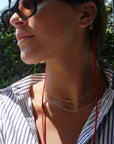 Red Magnetic Cord Strap Necklace For Eyewear Women's, Men's, Kids on a model with glasses- Camille Jewelry