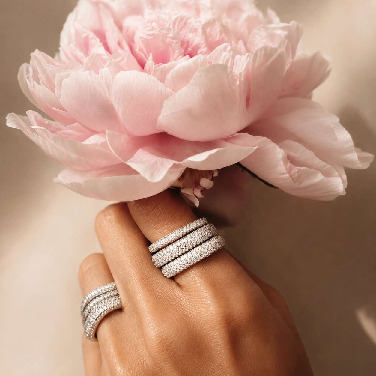 Pave square stacking rings on a hand by Camille Jewelry