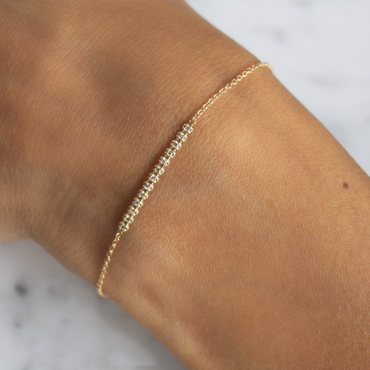 Diamond Bar Bracelet – 14K yellow Gold Pavé Fine Jewelry on models arm by Camille Jewelry