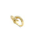 Diamond hook ring in solid 14K yellow gold with pavé set diamonds on a white background by Camille Jewelry top view