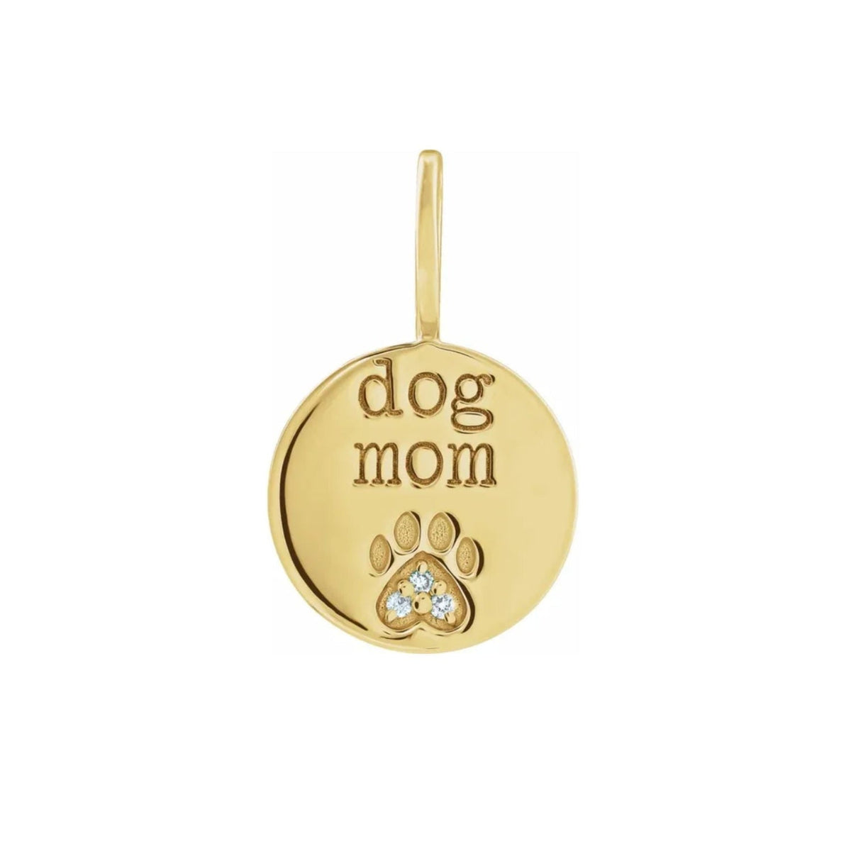 A 14k yellow gold round diamond paw print charm engraved with 'dog mom', shown on a plain white background, by Camille Jewelry