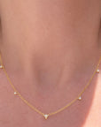 triangle diamond necklace close up on models neck - Camille ewelry