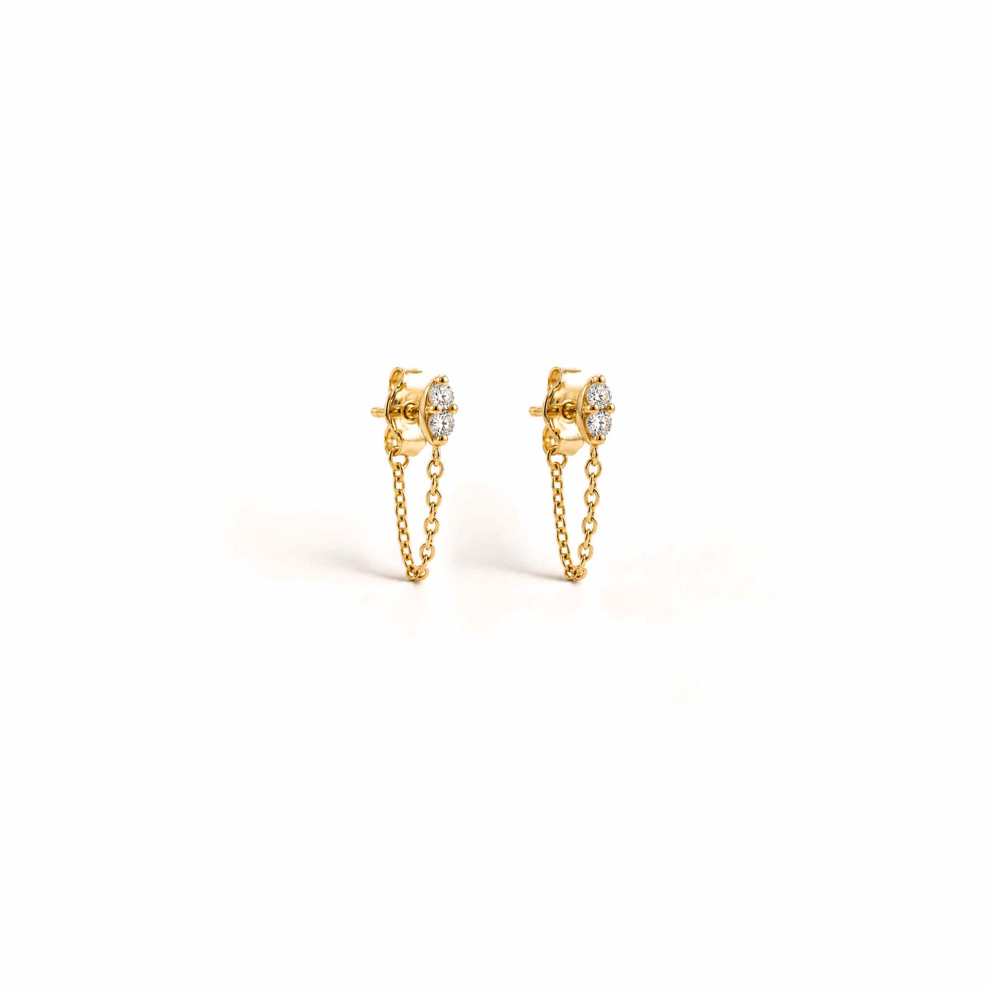 Diamond studs with locking backs in 14K yellow gold with marquise silhouette on a white background by Camille Jewelry